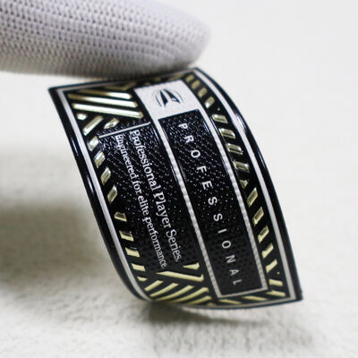 স্পোর্টসওয়্যারের জন্য কাস্টম টিপিইউ হাই-ফ্রিকোয়েন্সি প্যাচ - মেটালিক গোল্ড ও ব্ল্যাক প্রফেশনাল প্লেয়ার সিরিজ ব্যাজ